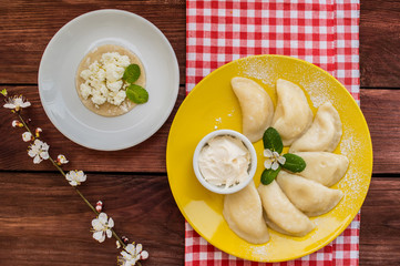 Dumplings with cheese for breakfast. Wooden table. Top view