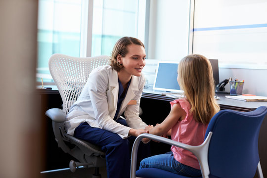 Pediatrician Talking To Child In Hospital