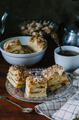 Traditional Russian homemade cake Napoleon, puff pastry custard cream pie on wooden table, rustic style