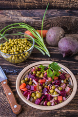 Salad Vinaigrette of beets on a wooden background. Top view