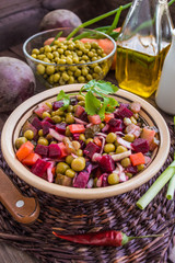 Salad Vinaigrette of beets on a wooden background. Top view