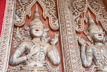 Wall-Carved Guardian Statues at Haw Phra Kaew Complex in Vientiane, Laos