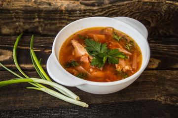Soup from Ukraine. Based on beef and vegetables. Very tasty  appetizing. At the rustic wooden background.