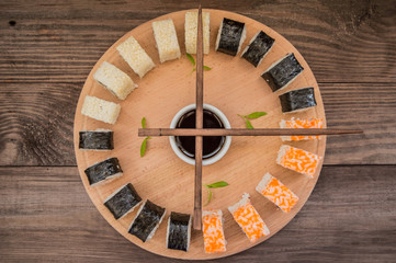 Sushi Set sashimi and  rolls on a wooden board.  background. Top view
