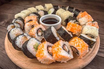 Sushi Set sashimi and  rolls on a wooden board.  background
