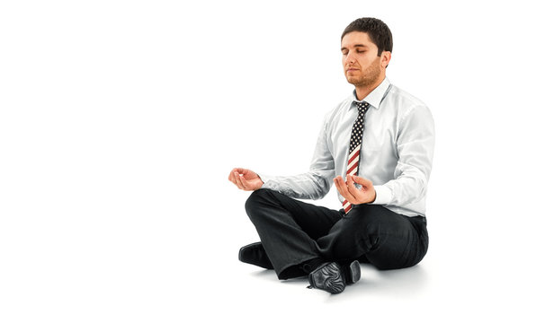 Businessman meditating in lotus pose