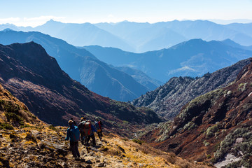 Group of People with Backpacks walking on Trail on Himalaya Trek