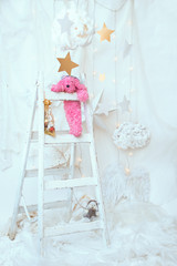 Plush pink dog, a ladder Christmas spirit