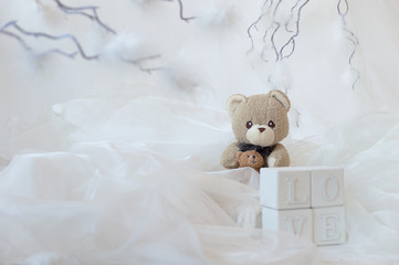 Teddy bears, white, elegant background of white cubes LOVE