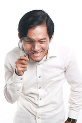 Happy Asian Man With Magnifying Glass