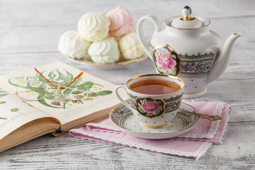 With a Cup of tea on a stack of books