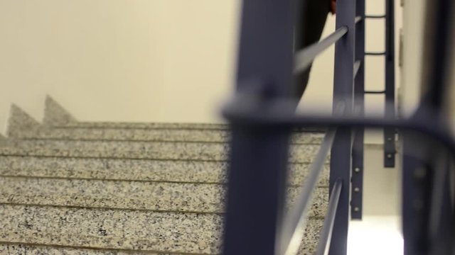 Young woman go upstairs - close up legs