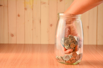 The man took the coins out of the bottle.