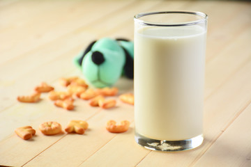 The doll dog, cookies and glass milk placed in front.