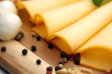 Cheese platter with different cheese and grapes - some emmental, gauda, parmesan and brie cheese on a table for brunch