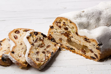 Christmas stollen on white wooden background