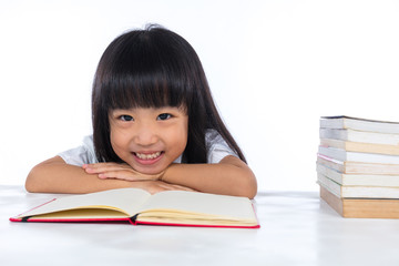 Smiling Asian Chinese little girl reading book