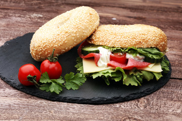 Delicious bagel sandwich with Lettuce and Tomato on the table