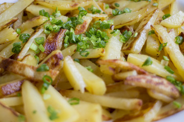 Fried potatoes decorated with green onions