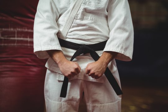 Mid section of karate player making fist