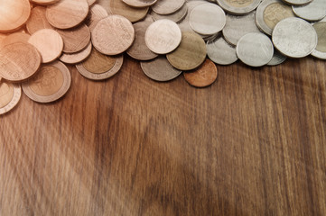 Close up and selective focus point on coin textures on wooden fl