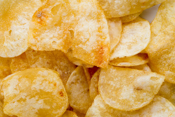 Close up potato chips on wood top view background.