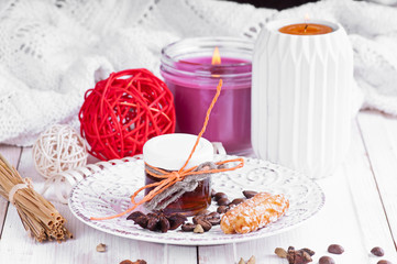 small jar with honey on a vintage saucer decorated with seeds of anise and cardamom coffee