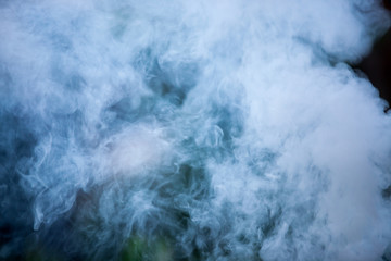 Fluffy Puffs of Smoke and Fog on Black Background.