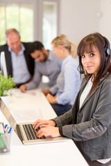 Smiling pretty business woman with headset