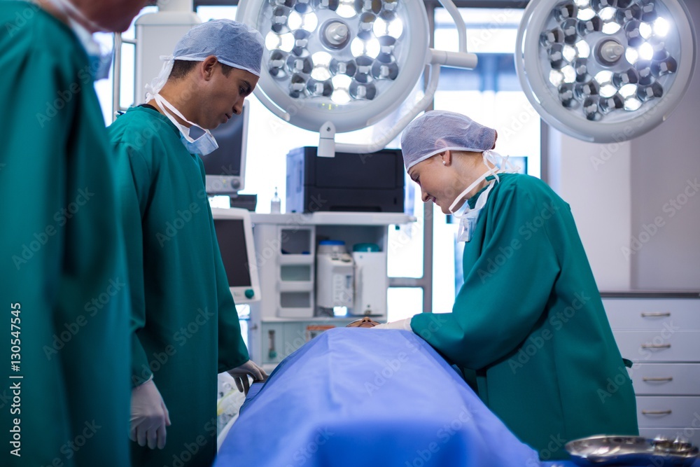 Poster surgeons performing operation in operation theater