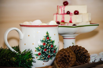 New year still life with sweets. Cup of coffee with marshmallow and marshmallow sticks with cranberries
