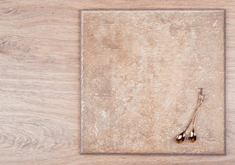 Golden spoon with crystals on a wooden background