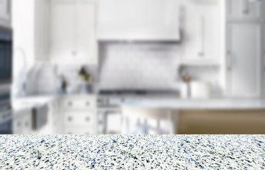 empty granite surface for the product with the  blurred kitchen