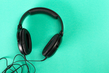 Headphones on green background