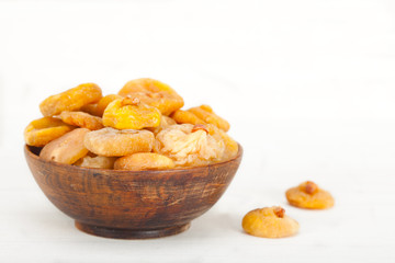 Delicious dried figs in wooden bowl on white