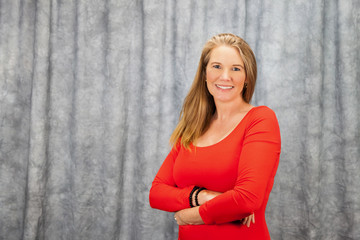 Fototapeta premium Blonde Female In Red Dress with Arms Folded 