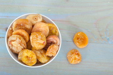 Natural organic dried figs in bowl, top view