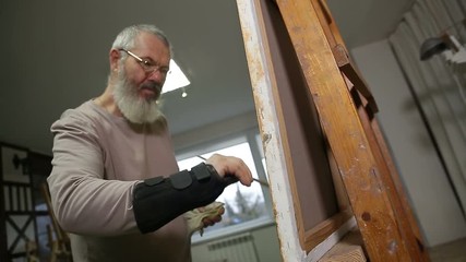 Artist working on painting.