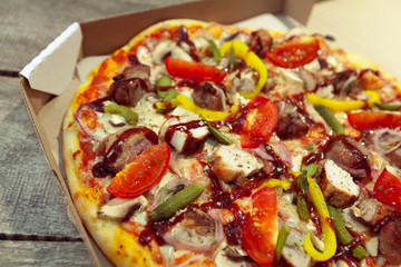 Fresh tasty pizza on wooden background