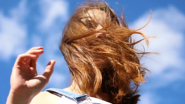 Seductive young woman on a windy day