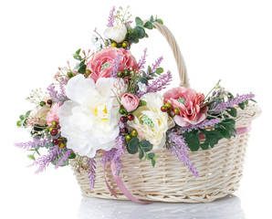 basket with flowers to celebrate Easter on a white background