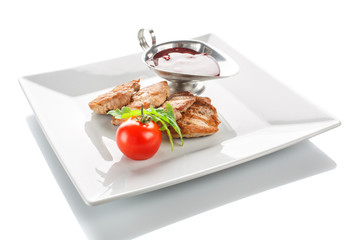 A grilled serving steak with tomato and fresh herbs and sauce