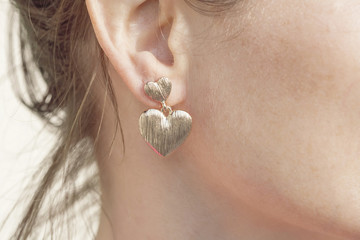 Woman wearing a heart shape earring