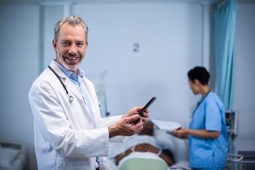 Fototapeta premium Portrait of doctor using digital tablet in ward