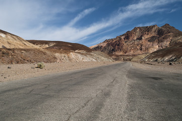 Desert landscape and narrow road of the scenic Artist Drive in the Death Valley National Park, CA