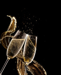 Two glasses of champagne over black background