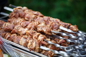 steak meat on metal kebab skewers
