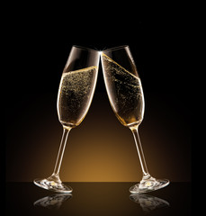 Two glasses of champagne over black background