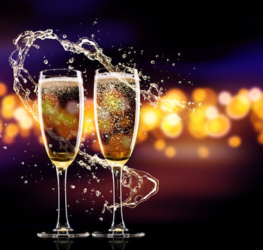 Two glasses of champagne over blur spots background