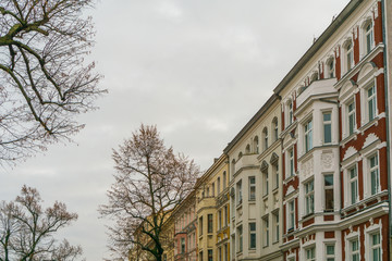Fototapeta na wymiar beautiful apartment houses in a autumn street with trees
